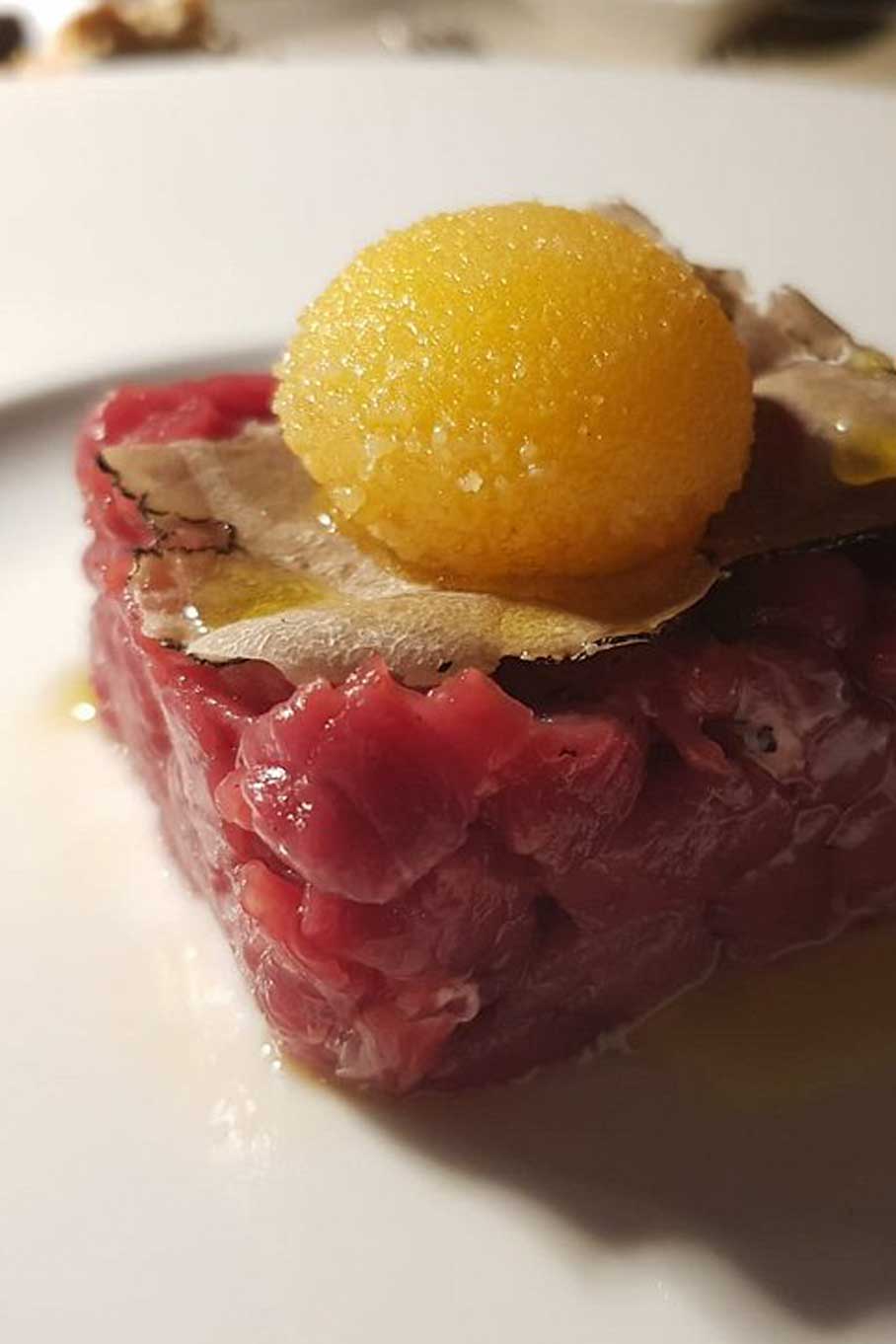 Chianina beef tartare with crispy egg yolk and black truffle – Tipico Osteria Montone